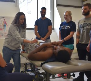 demonstrating ultrasound on a UConn student